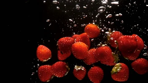 Red strawberries in slow motion falling into water Stock Footage 138989227