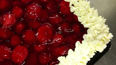 Red strawberry cream cake, with whipped cream, at a restaurant kitchen Stock Footage 59674129