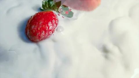 Red strawberry falling in milk in slow motion. Stock Footage 145349871