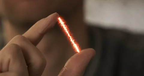 Red stream of energy appears between fingers. Visual effect, close-up. Concept Vídeos de archivo 256165142