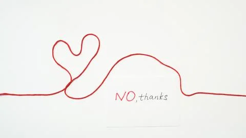 Red string forming heart shape with note saying NO, thanks on white backgroun Stock Photos