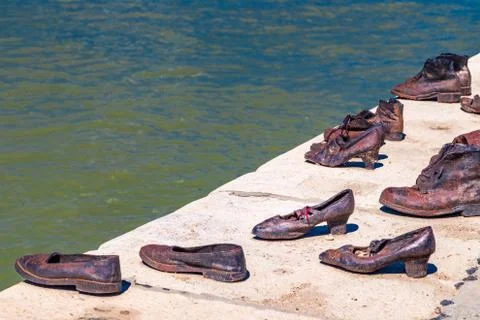 Red string on shoe on the Danube promenade Stock Photos