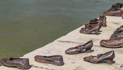 Red string on shoe on the Danube promenade Stock Photos