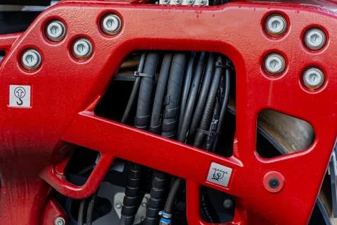 Red structural metal frame with hydraulic hoses Stock Photos