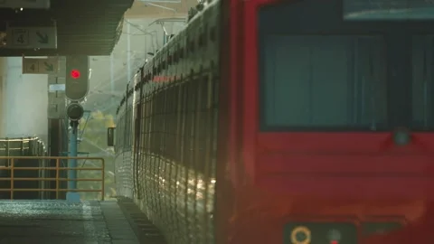 Red subway train approaching station platform Stock Footage 347982289