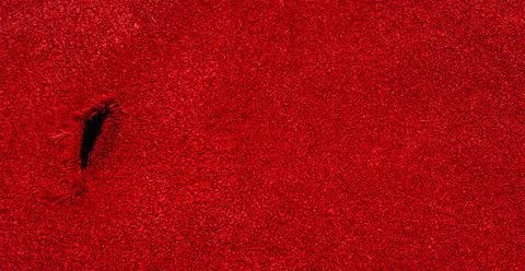 Red suede web size with a hole on one side. Stock Photos