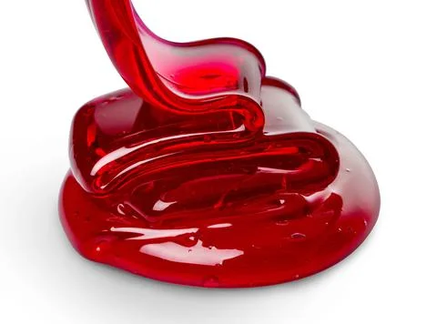 Red sugar paste for depilation close-up on white background. Stock Photos