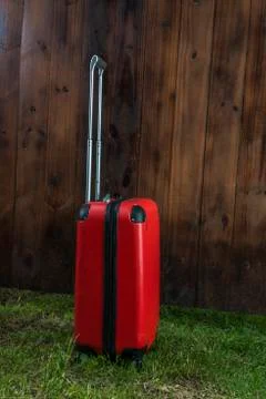 Red suitcase on the grass Stock Photos