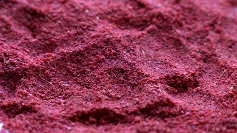 Red sumac spice powder falling down close up Stock Footage 263810260