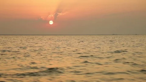 Red sun and sky at sunset from a boat at sea on a summer day Stock Footage 79596380
