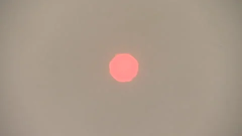 Red Sun Behind Haze of Burning Peatland, Indonesia Video stock 142850424