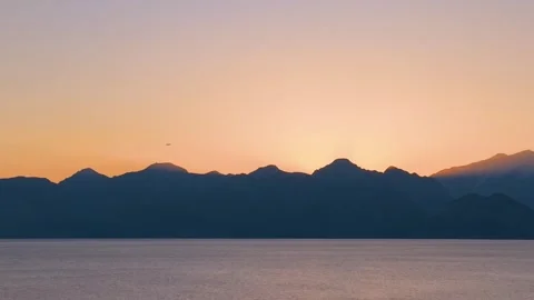 Red sun rising through the mountains Stock Footage 240484164