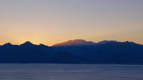 Red sun rising through the mountains Stock Footage 240484335