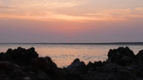 Red Sun Setting Behind Cloud Band Stock Footage 305957269