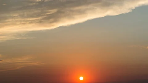 Red sun, setting down through melting rainy clouds Stock Footage 144638203