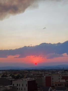 Red sun setting over almassora urban skyline Stockfoto's
