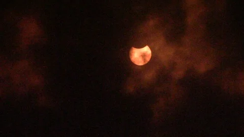 Red Sun Solar Eclipse Partial Dark Clouds 3 Stock Footage 89857336