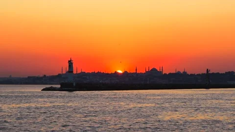 Red sundown in the Bosphorus strait. The lighthouse and silhouettes of Blue Stock Footage 250093873