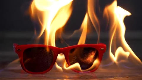 Red sunglasses set on fire Stock Footage 141250027