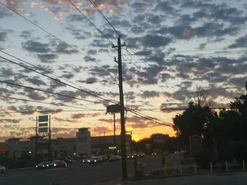 Red Sunset Behind Light Scattered Clouds - Beautiful Sky in Houston, Texas Stock Photos