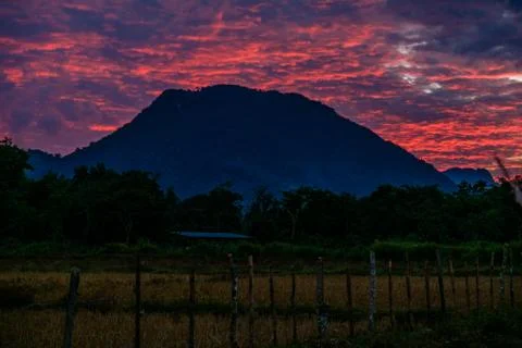 Red sunset behind a mountain Stock Photos