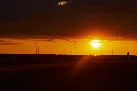 Red sunset with clouds after rain in the steppe Stock Photos