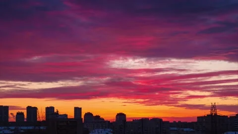 Red sunset clouds in evening sky over urban city skyline silhouette. Time lapse. Stock Footage 224708837