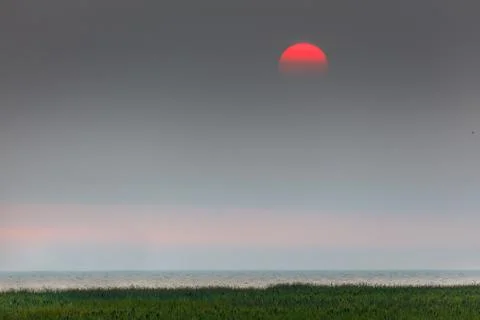 Red sunset in a haze Stock Photos