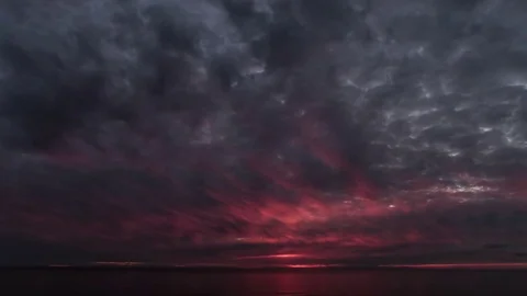 Red Sunset Light rays through the clouds over the sea time lapse Stock-Footage 83795773