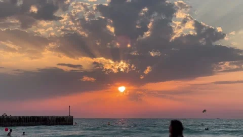 Red sunset with moving person from one side to another, sun and clouds with sea Stock Footage 236349518