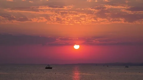 Red sunset over calm ocean ripples Stock Footage 97973908