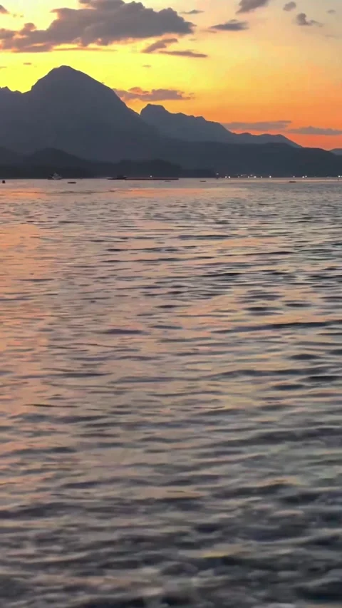 Red Sunset Over Mediterranean Beach with Pier Silhouette and Mountains Stock-Footage 332854749