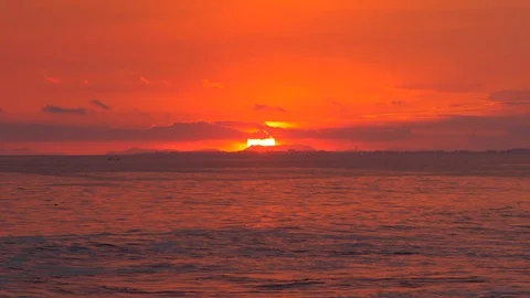 Red Sunset over Ocean behind City and Mountains Video stock 116989696