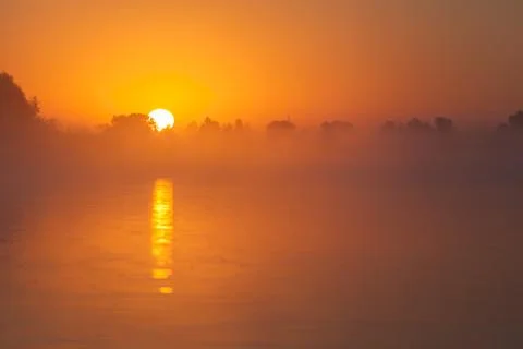 Red sunset over river Stock Photos