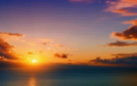 Red sunset over the sea, rays of light.Natural blurred backgroun Stock Photos