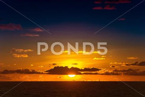 Red sunset over the sea, rich in dark clouds Stock Photos
