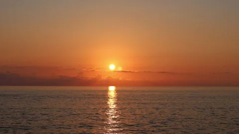 Red Sunset Over the Sea with the Sun Setting Below the Horizon Stock Footage 346622143