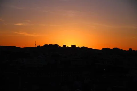 Red sunset with the shape of the buildings Stock Photos