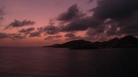 Red sunset sky is reflected in sea, and dark cloudscape replicating silhouette Stock Footage 274815684