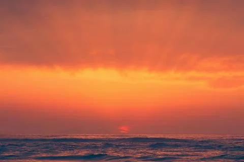 Red sunset with sun beams Stock Photos