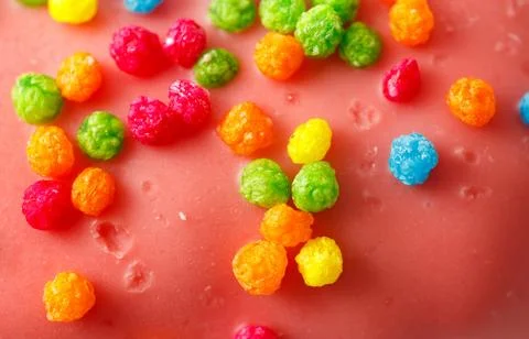 A red surface with colorful candy on it 스톡 사진