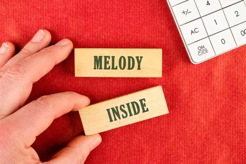 On a red surface, a hand holds a block with the word INSIDE, while another block Stock Photos