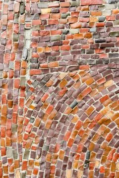 Red Surface of old crumbling abstract decorative mosaic as background. Multic Stock Photos