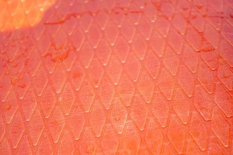 A red surface with a pattern of squares and triangles 写真素材