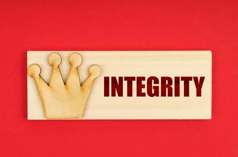 On a red surface there is a wooden block with the inscription - Integrity Stock Illustration
