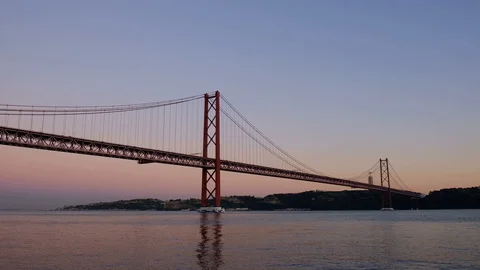 Red suspension Bridge 25 de Abril over Tagus/Tejo River in Lisbon Stock Footage 129970160