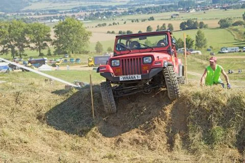 Red SUV at difficult terrain Stock Photos