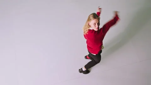In a red sweater pretty lady dancing in front of the camera in a white Video stock 131559613