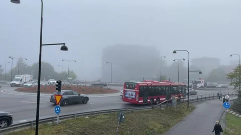 Red Swedish SL bus. Mist in the city. Stock Footage 286251425