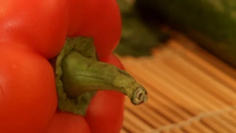 Red sweet pepper lie next to a lettuce leaf, especially close-up Stock Footage 85609986